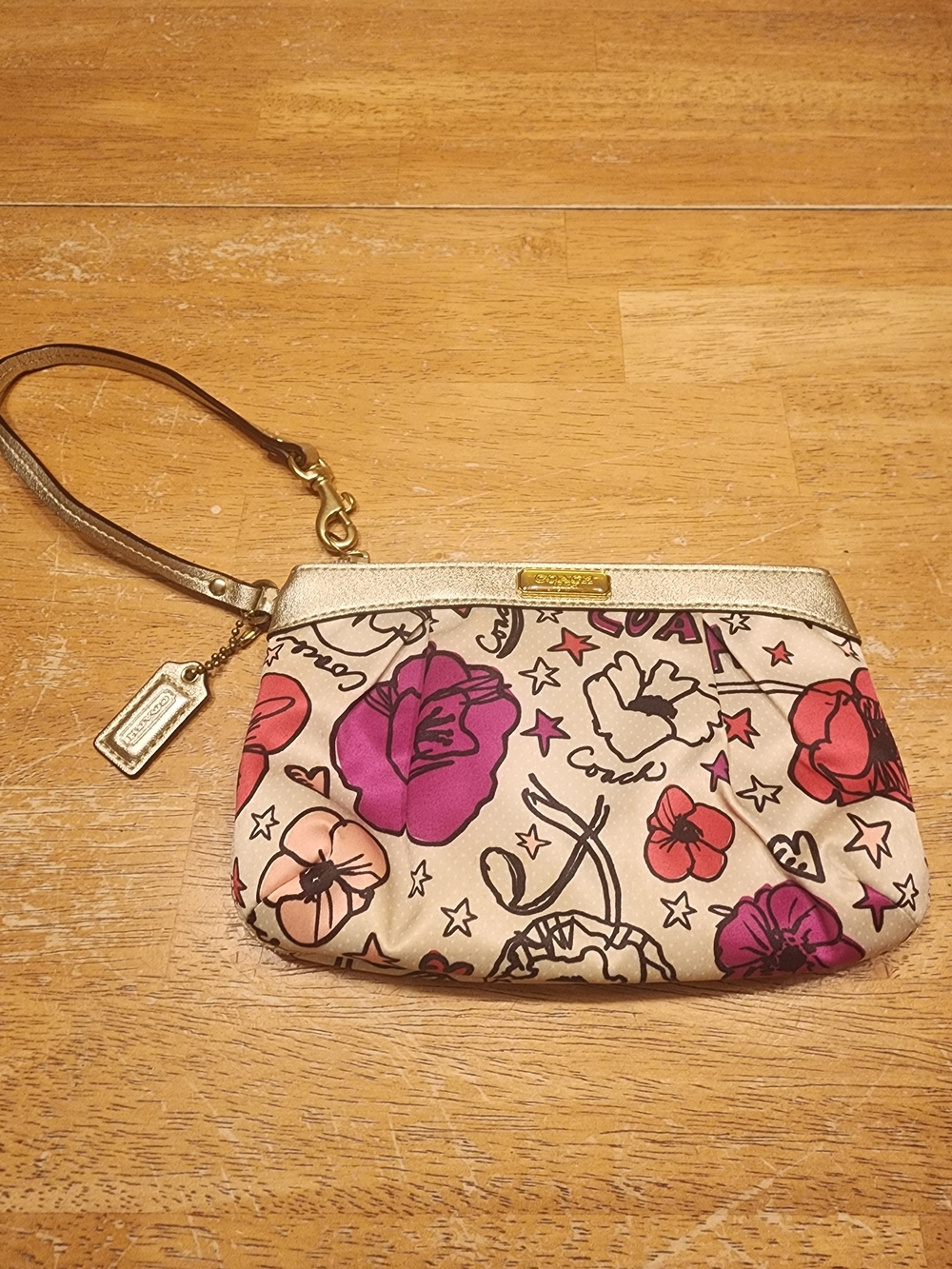 Coach Poppy Kyra floral print wristlet with gold leather trim